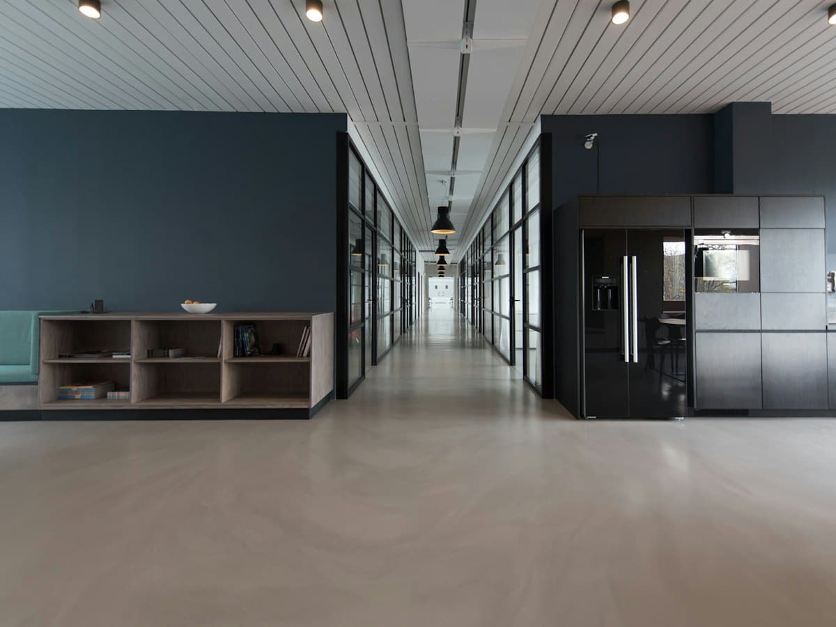 Empty commercial interior with polished floors and recessed lighting